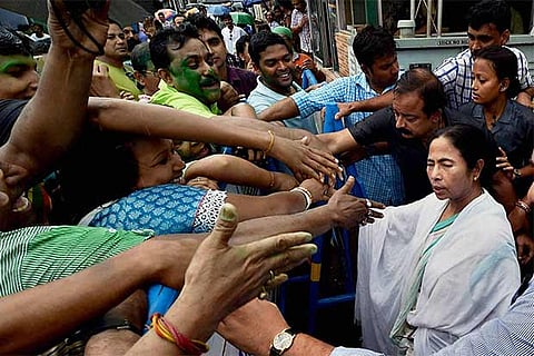 West Bengal CM Mamata Banerjee flashes victory sign with party leaders