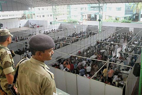 Security personnel keep a watch during vote counting for Kerala assembly elections in Kozhikode