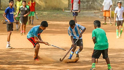 Young hockey enthusiasts practice the game at a summer coaching camp