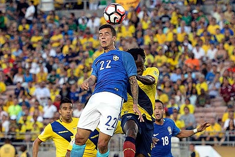 Brazil?s Philippe Coutinho (left) goes for a header