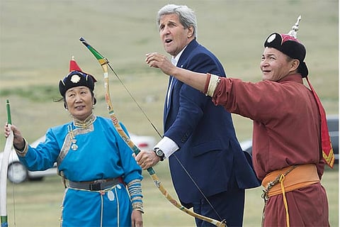US Secretary of State John Kerry reacts after shooting a bow and arrow in a Naadam ceremony