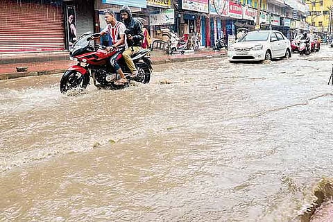 Vehicles wading through a flooded road in Kanniyakumari