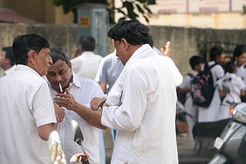 Smokers seen lighting up cigarettes near a school in the city (Photo: Justin George)