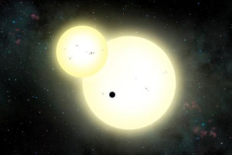 An artist rendering shows a planet, dubbed Kepler 1647 b, the small black dot, as it orbits two suns