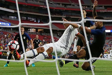 Carlos Bacca (left) of Colombia scores against US during their Copa America third place match