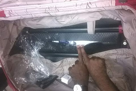 Customs and intelligence officials with the seized suitcase with the drug concealed cleverly