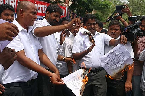 Members of the Madras High Court Advocates? Association burning copies of the Government Gazette