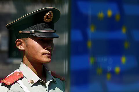 A Chinese guard keeps watch at the Delegation of the European Union to China in Beijing