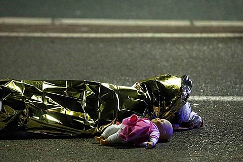 A body is seen on the ground after at least 30 people were killed in Nice, France