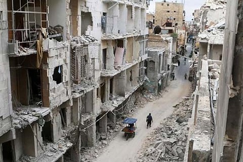 Residents walking through the streets of Aleppo that witnessed heavy damage