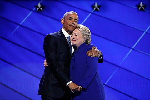 Democratic presidential nominee Hillary Clinton hugs U.S. President Barack Obama