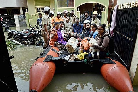 Karnataka Fire and Emergency service personnel rescue some families on boat in Bengaluru