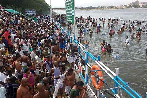 Devotees taking a holy dip in the Cauvery at Amma Mandapam in Srirangam in view of Aadi Perukku
