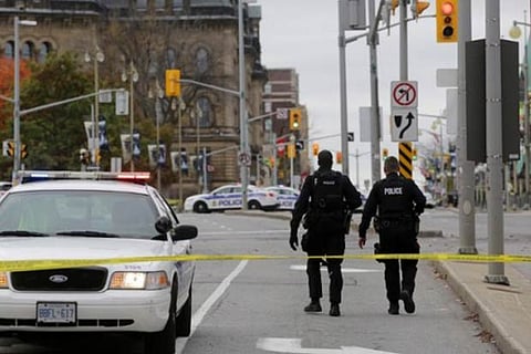 File photo of Ottawa police officers walk near the National War Memorial