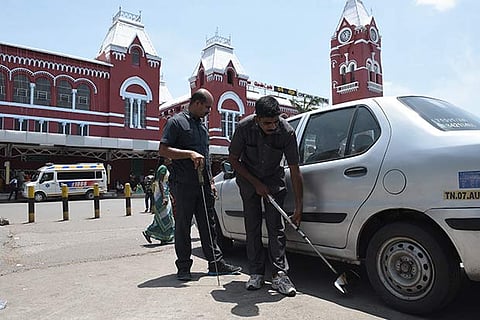 Security personnel scanning a vehicle entering the Chennai Central station