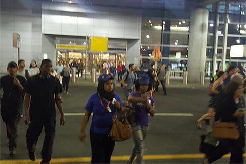 Passengers evacuate Terminal 8 (Image: Robbie Rob, Twitter)