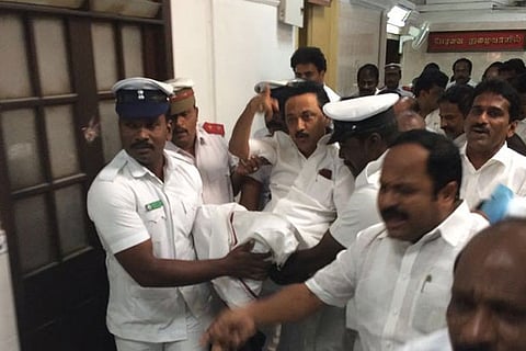 Leader of Opposition MK Stalin being carried by marshalls out of the Assembly