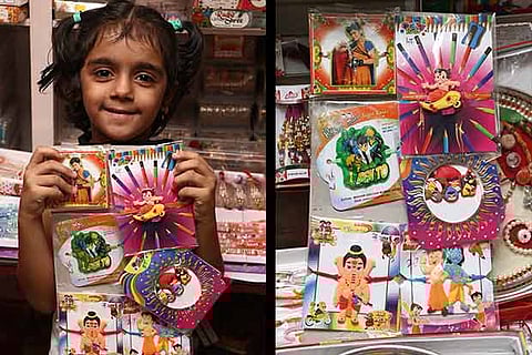 A happy shopper proudly displays her rakhi collection (Photo: Prakaash)