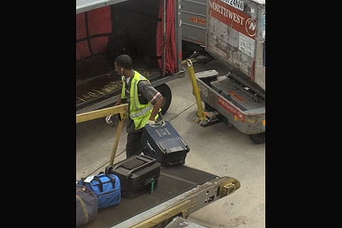 A worker loading baggage into an aircraft