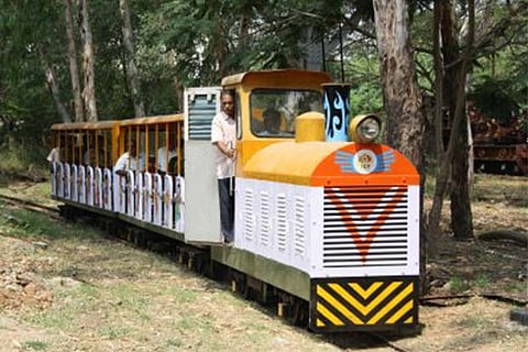 Passengers taking a ride on a toy train at the Chennai Rail Museum