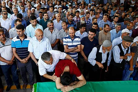 Relatives of a victim of Saturday?s bombing mourn at a funeral, in Turkey