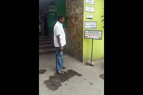 A man reading the board announcing prizes for using crematorium toilet