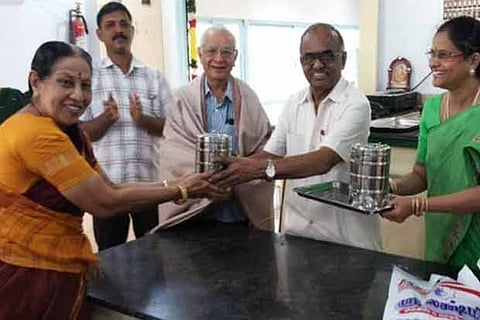 Dr VS Natarajan hands over specially cooked food at the launch of a catering service