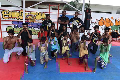 Participants pose at a workshop as part of the ?Fight for your future? initiative by Combat Kinetics