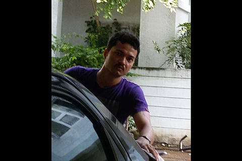 Manoj cleaning a car as part of his daily routine