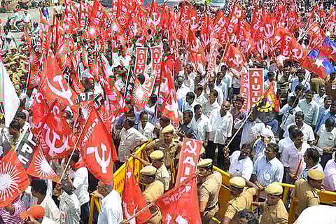 Members of various trade unions staging a protest on Pallavan Salai in Chennai on Friday