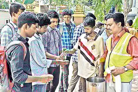 Residents being given 'nilavembu' syrup by Corporation workers and students in Mylapore on Friday