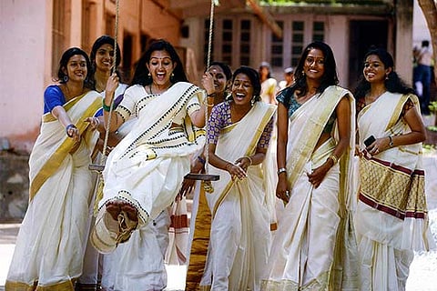 Girls enjoy on a swing during the Celebration of Onam Festival in Thiruvananthapuram