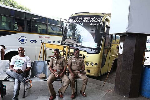 Police personnel guarding KSRTC buses parked at Chennai Mofussil Bus Terminus (CMBT) in Koyambedu