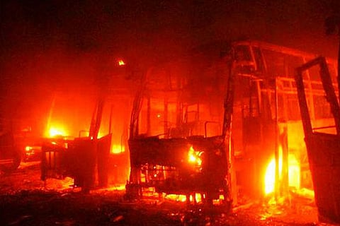 File photo of buses belonging to state-based private transport firm being burnt in Bengaluru