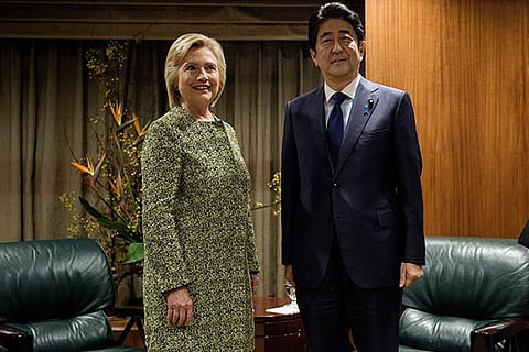Democratic presidential nominee Hillary Clinton (L) stands with Japanese Prime Minister Shinzo Abe