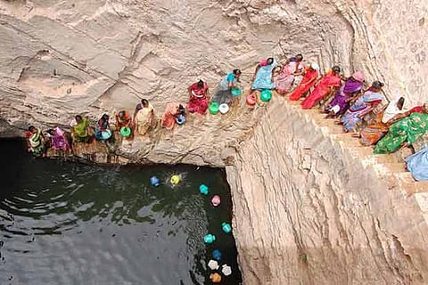 Women fetching water from a deep well at Vadaku Thittankulam near Kovilpatti