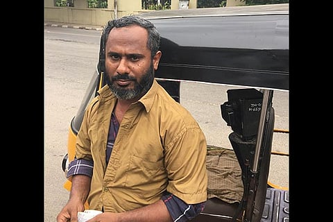 Auto driver Kithir Jamaal awaiting a customer