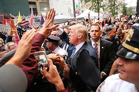 Donald Trump greets supporters outside of Trump Towers in Manhattan
