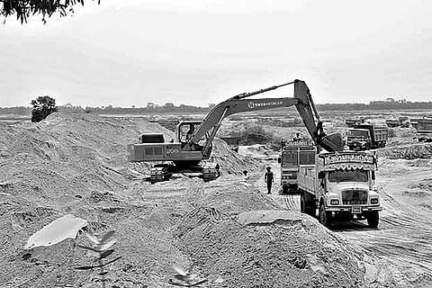 Sand being loaded onto lorries at an illegal quarry on the Cauvery bed in Ariyalur district