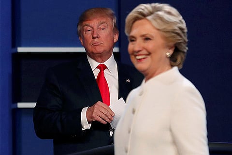 Donald Trump looks on as Hillary Clinton makes her speech