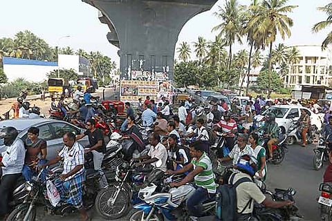 Bikes, cars and pedestrians jostling for space beneath the pillars of the MRTS