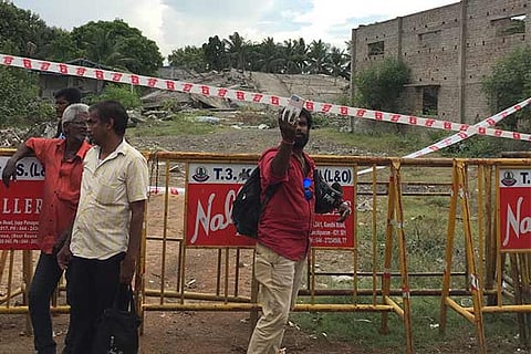 A passer-by taking a selfie at the demolition site at Moulivakkam