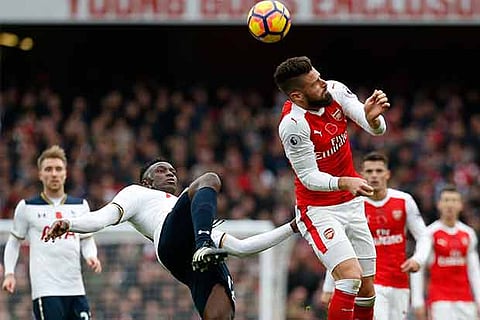 Tottenham Hotspur midfielder Victor Wanyama (left) vies for the ball with Arsenal striker Olivier