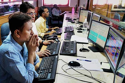 Brokers at BSE building react as Sensex plunges in reaction to the counting trends of US elections