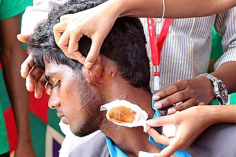 N Vivekanandhan gets first aid after a fellow athelete attacked him