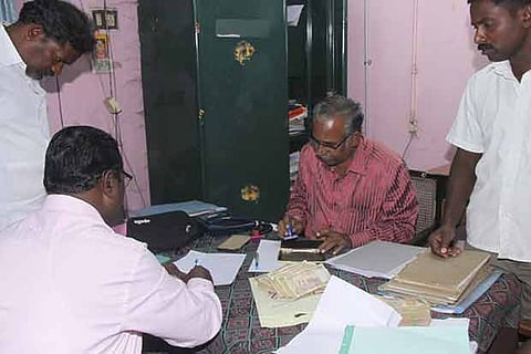 Officials inspecting the seized money of Rs 6.46 lakh in Thanjavur