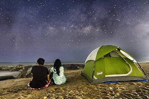 A couple stargaze at a camp by the sea on the East Coast Road near Kovalam