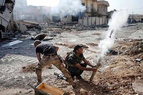 Iraqi special forces soldiers fire a mortar round at Islamic State fighters positions