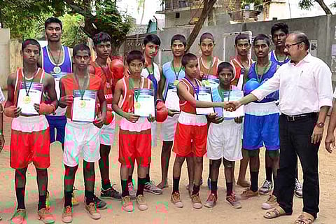 The boxing champions with the school officials