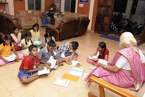 An old age home resident takes classes for children from nearby locality